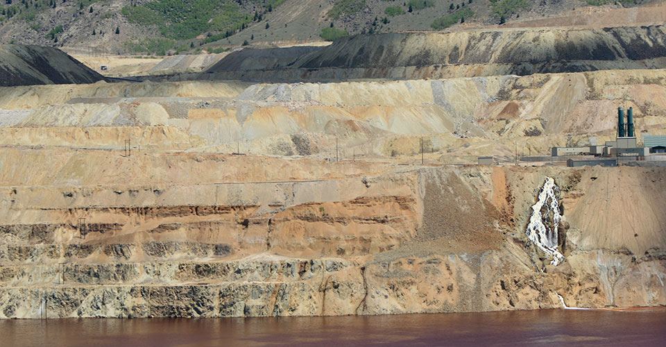 The waterfall on the southeast rim of the Berkeley Pit, near the Horseshoe Bend Water Treatment Plant as it appeared in 2009. The waterfall has stopped flowing since a Feb. 2013 slough from the Pit wall knocked out a pump used for Montana Resources copper precipitation plant. Prior to Feb. 2013, the waterfall was created by Pit water returning after Montana Resources had removed most of the copper in the water in its precipitation plant. Photo by Justin Ringsak.