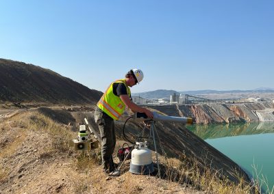 A worker presses a propane cannon used in the waterfowl protection program at the Berkely Pit.